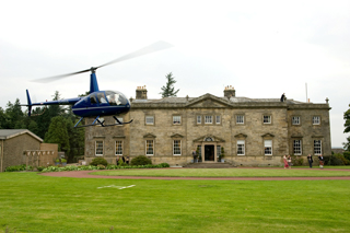 Weddings - Helicopter landing outside Manor House, where the wedding will occur